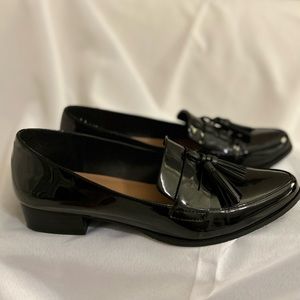 Black patent leather loafers with tassels. In excellent used condition.